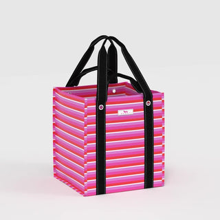 A structured open-top box tote in a multicolor horizontal stripe print of hot pink, red, purple, lavender, and white, with black woven webbing handles and silver grommeted strap attachments, shown on a light gray background.