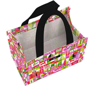 A small structured tote bag with a geometric grid print featuring holiday motifs in pink, green, red, and white, with short black webbing handles, photographed against a white background.
