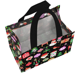 A structured, box-shaped small gift bag with a black background covered in multicolor holiday icons — Santa, snowmen, Christmas trees, ornaments, and gift boxes — featuring a clear vinyl front panel and dual black woven handles with metal grommets.