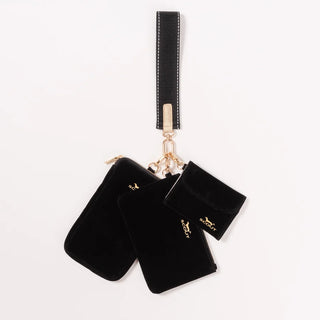 Three-piece black velvet organizer set including a wristlet strap, a zip pouch, and a snap card case, all connected by a gold-tone carabiner clip, displayed on a white background.